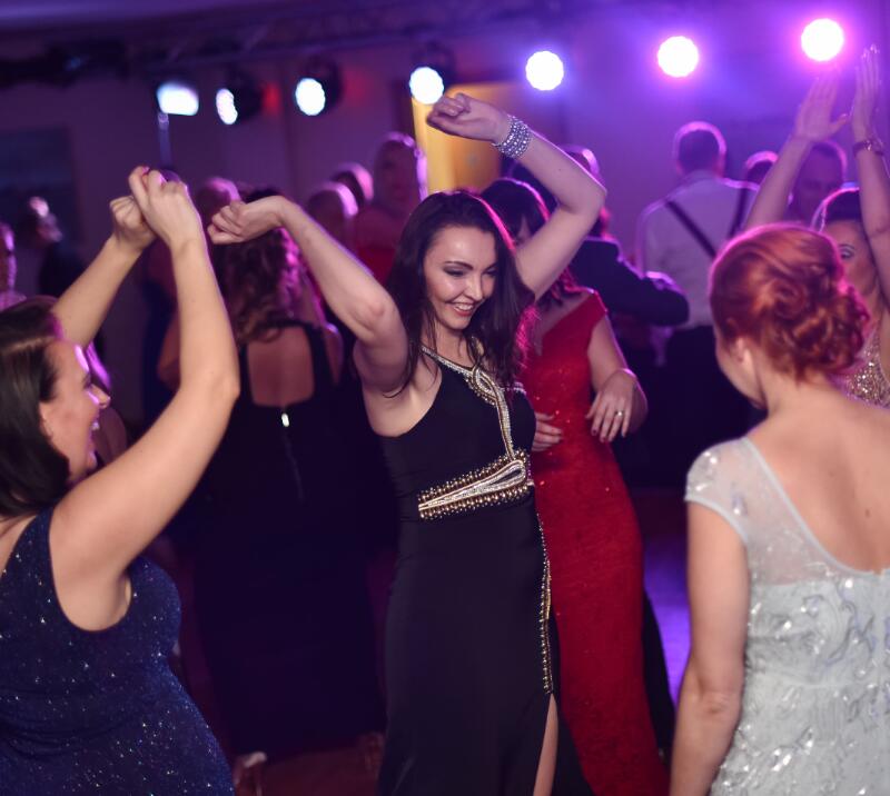 A group of people dancing on the dance floor at New Year