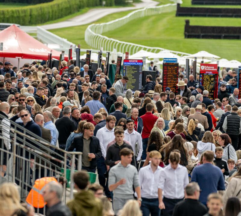 The crowd surrounding the many bookmakers at Lingfield Races