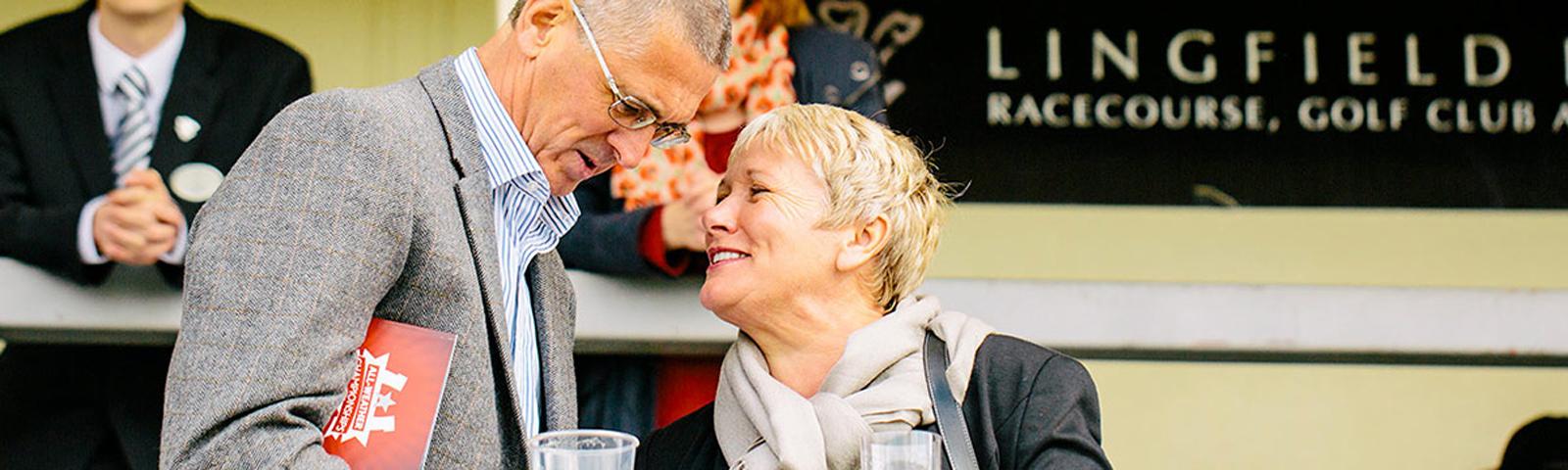 A couple chat during a break in hte action at Lingfield Park Racecourse