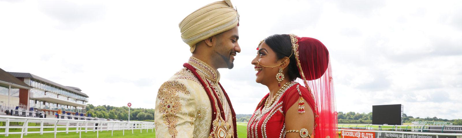 Asian couple celebrating their wedding, standing on the track.