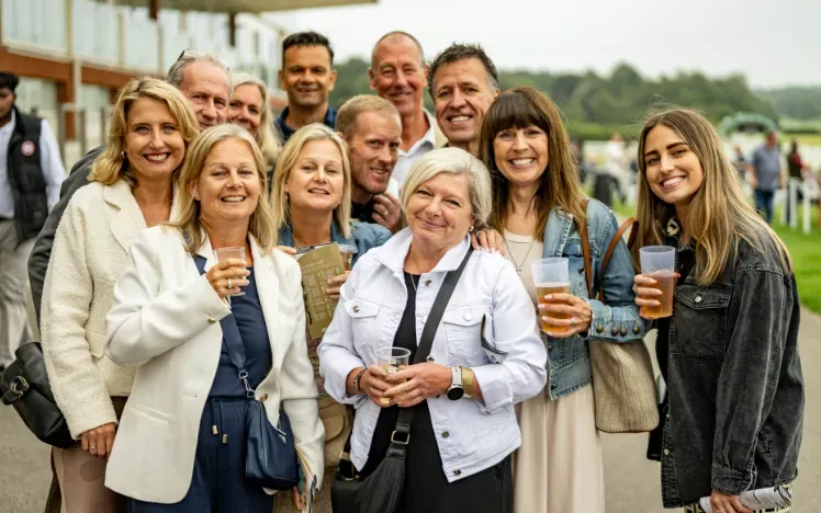 A group of smiling guests at Lingfield Park