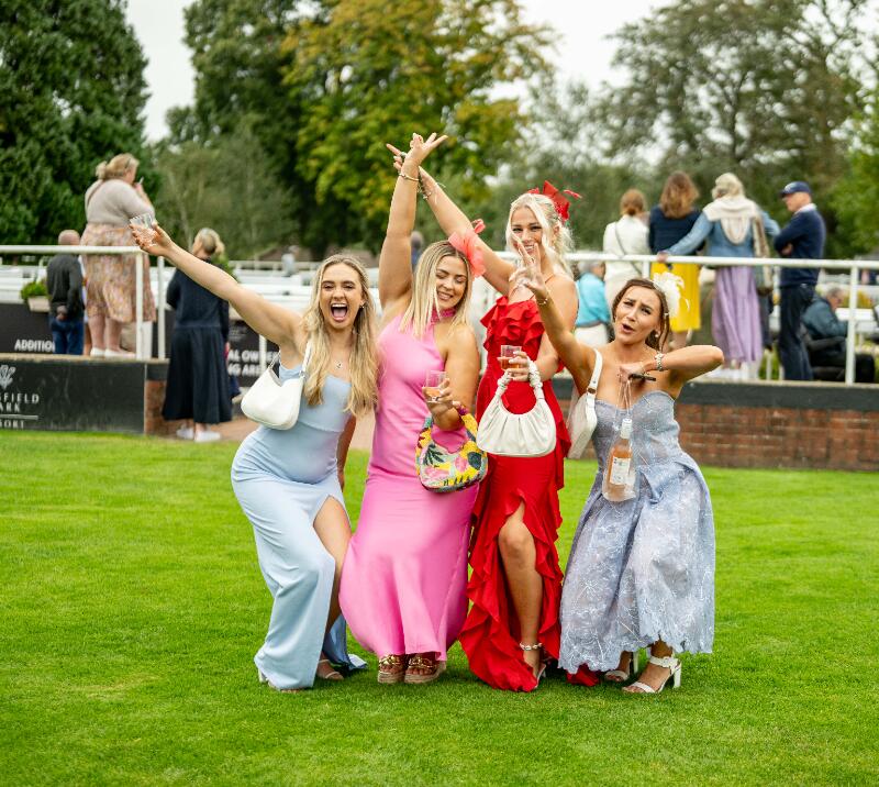 A group of young races goers on the lawn at Lingfield