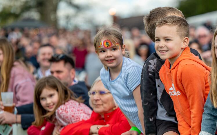 Kids line up next to the track during Good Friday racing at Lingfield Park