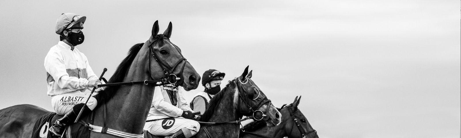 Horses and masked jockeys race behind closed doors at Lingfield Park Racecourse