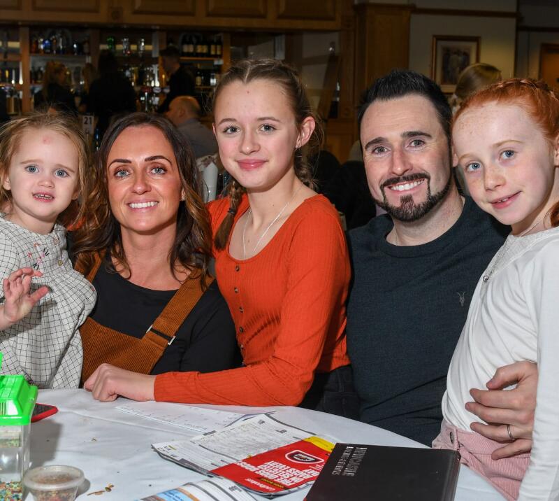 A family enjoying hospitality at a bonfire night event.